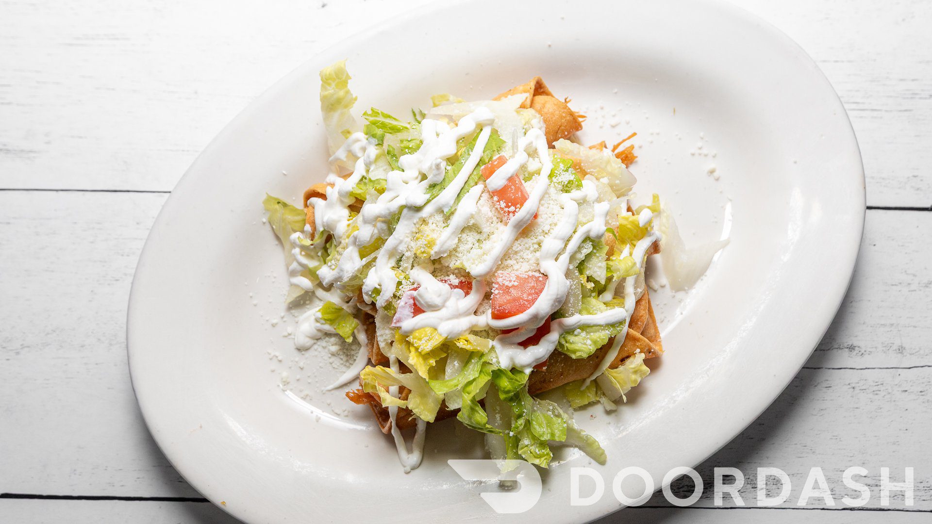 Mexican tostada with lettuce and cream