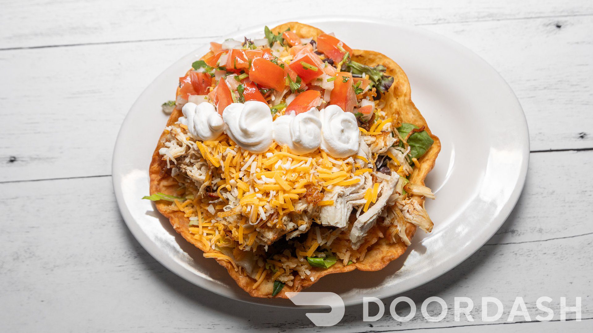 Tostada topped with cheese and tomatoes