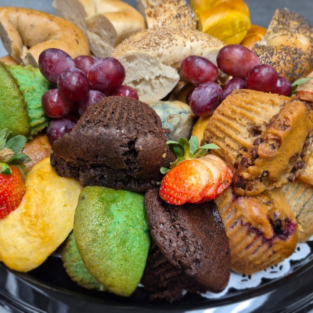 Variety of baked goods with fruit garnish